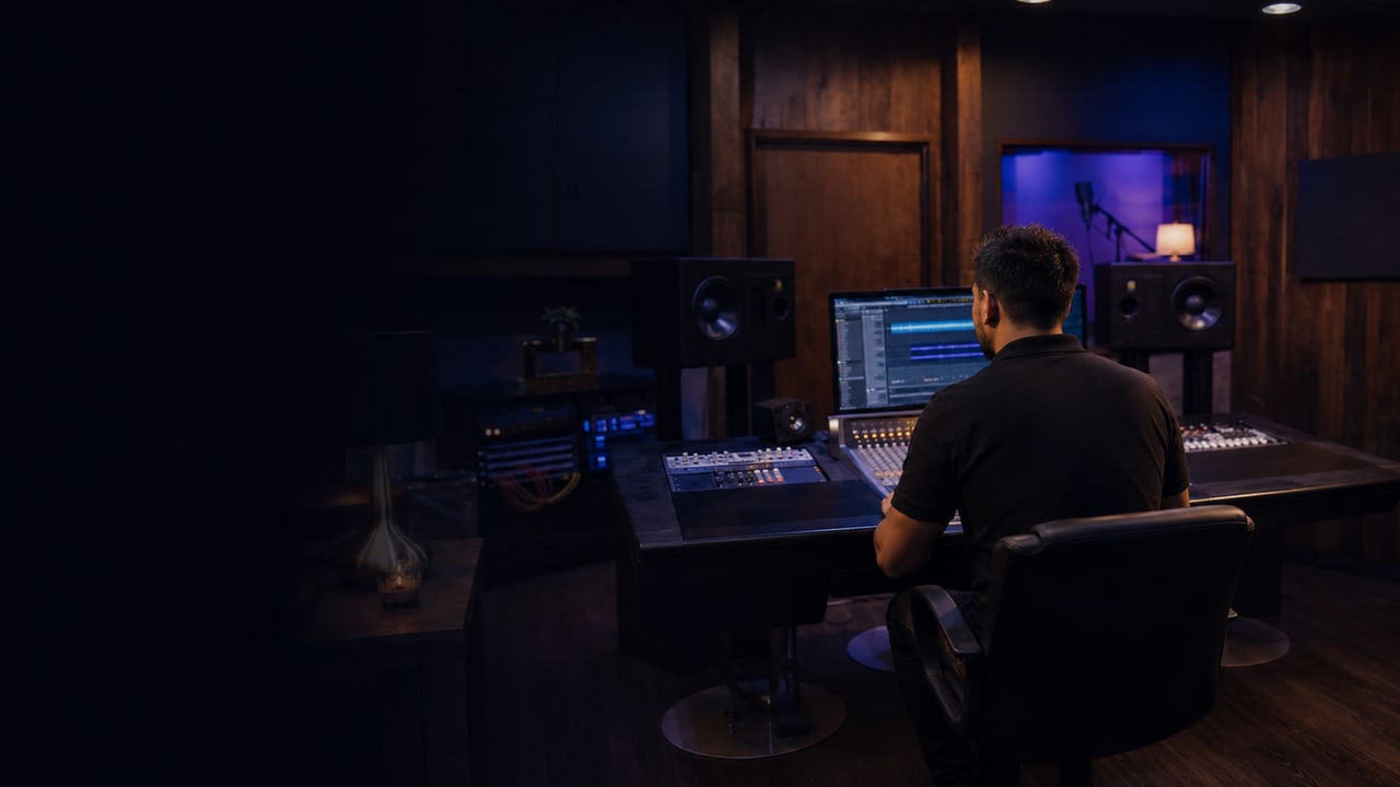 Apollo Soundworks producer working at a professional studio console